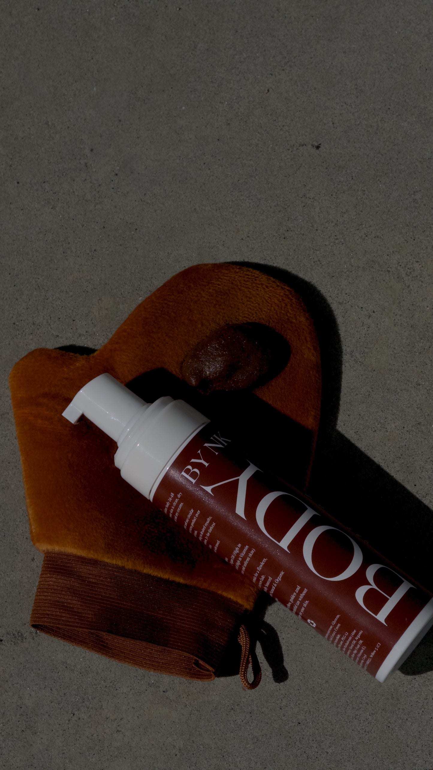Tube of Body by Victoria's Secret lotion on a brown textured surface