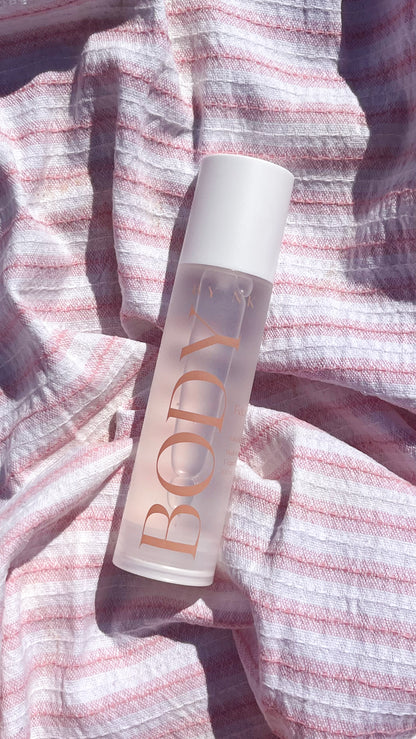 bottle laying on a towel at the beach